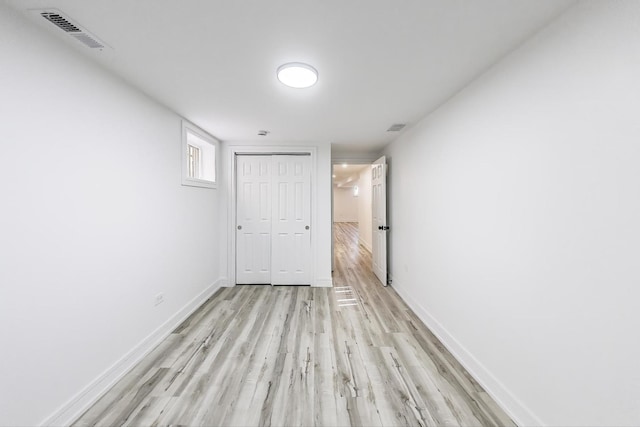 unfurnished room with visible vents, baseboards, and light wood-style floors