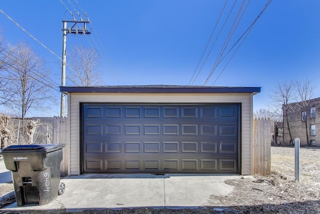 detached garage featuring fence