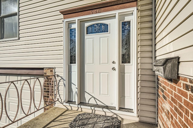 property entrance featuring brick siding