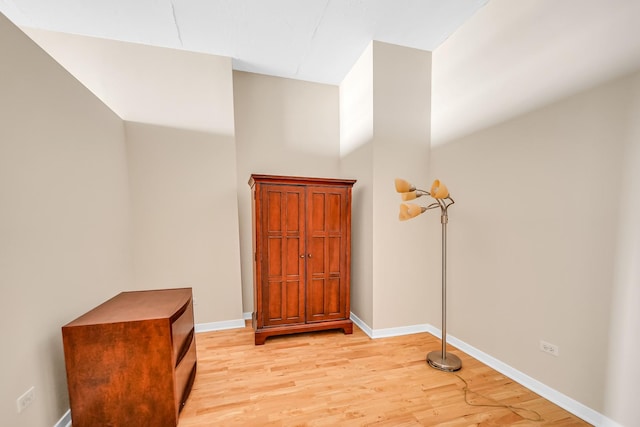 interior space with baseboards and light wood-type flooring