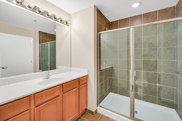 bathroom featuring vanity, a shower stall, and tile patterned floors