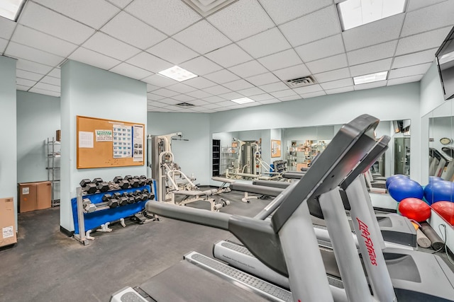 exercise room with visible vents and a paneled ceiling