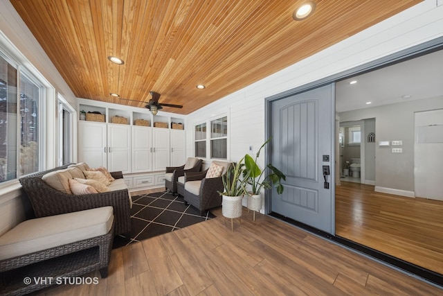 sunroom featuring wooden ceiling and ceiling fan