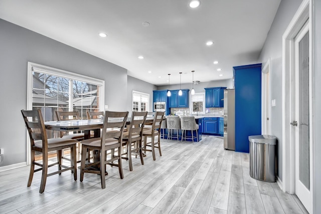 dining space featuring light wood finished floors and recessed lighting