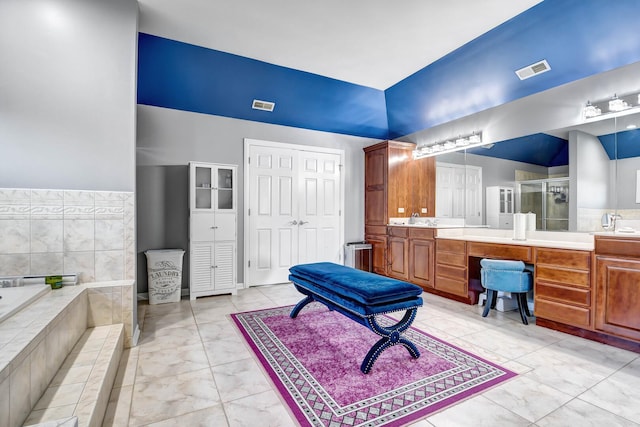 bathroom with visible vents, a stall shower, vanity, and a bath