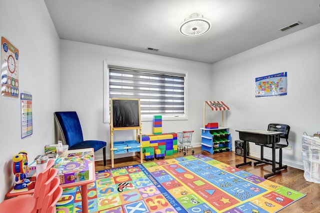 rec room featuring visible vents, baseboards, and wood finished floors