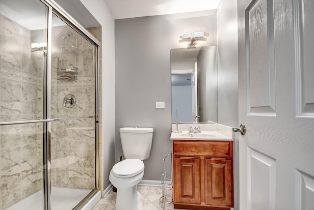 bathroom featuring toilet, marble finish floor, a shower stall, baseboards, and vanity