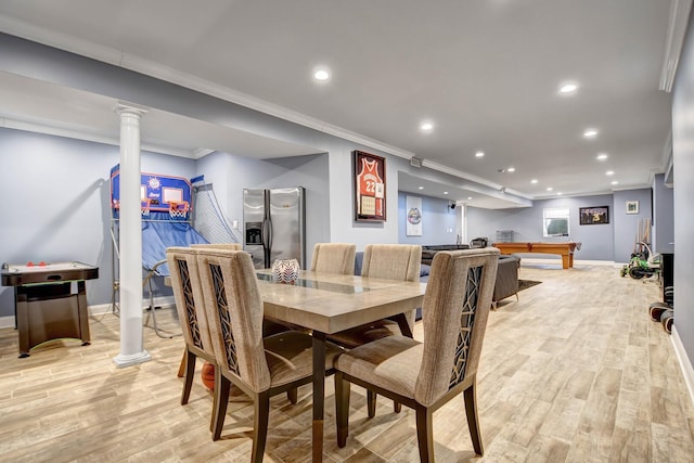 dining area featuring ornamental molding, recessed lighting, light wood finished floors, decorative columns, and baseboards