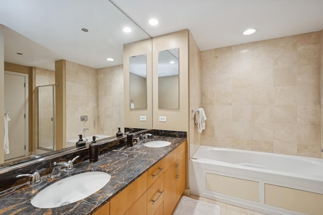 bathroom featuring a sink, a tub to relax in, and walk in shower