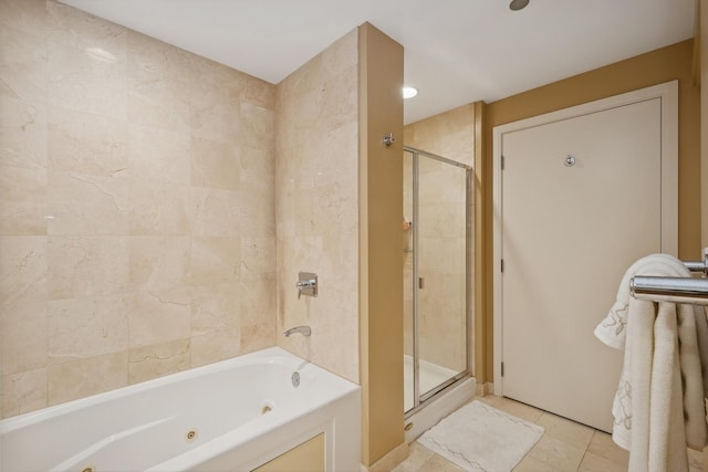 bathroom featuring a shower with door, a jetted tub, and tile patterned flooring