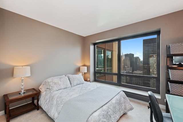 bedroom with light carpet and baseboards