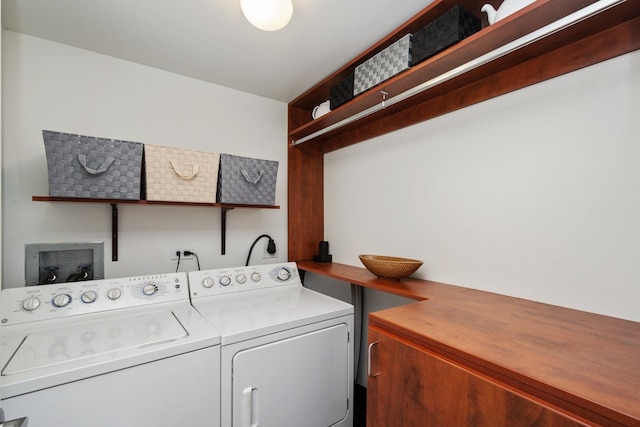 clothes washing area featuring laundry area and washer and clothes dryer