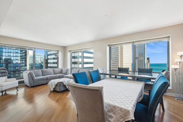 dining space with a city view and wood finished floors