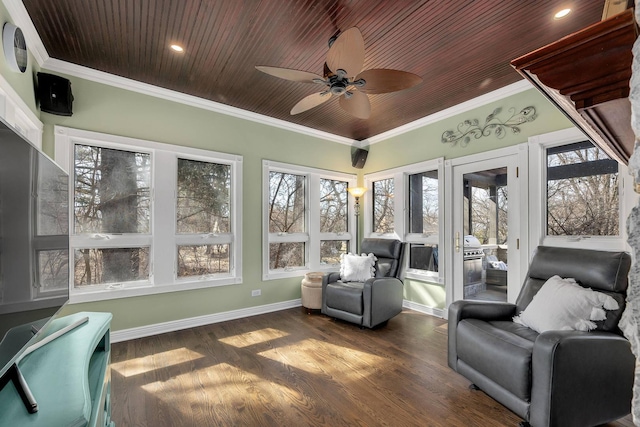 sunroom / solarium with wood ceiling and a ceiling fan