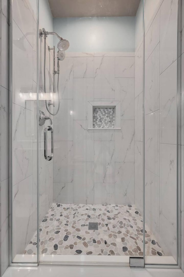 full bath with a shower stall