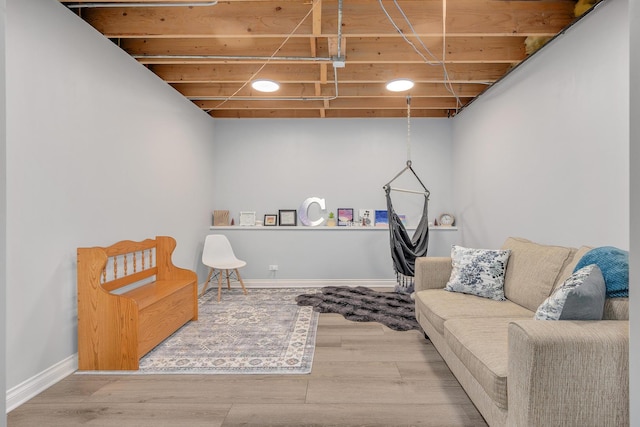 sitting room with baseboards and wood finished floors