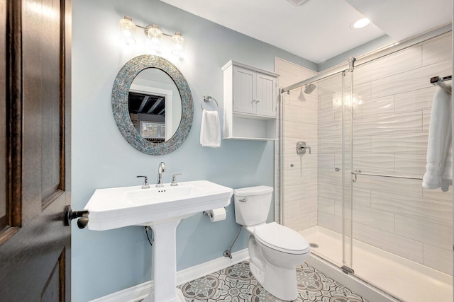 full bathroom with tile patterned floors, baseboards, toilet, and a shower stall