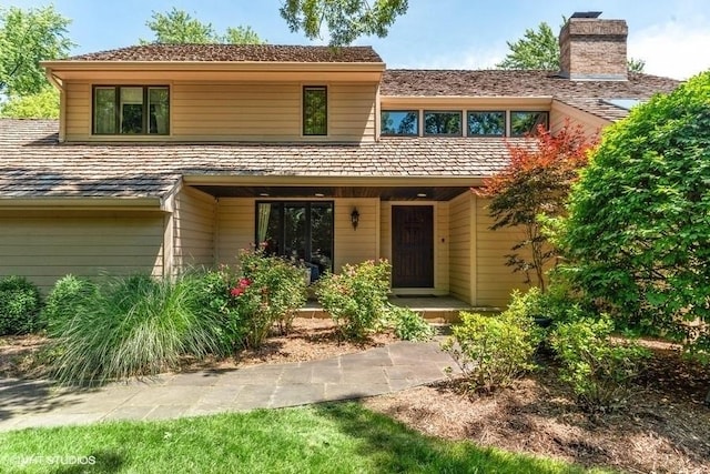 view of front of house featuring a chimney