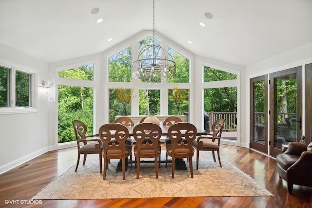 sunroom / solarium with vaulted ceiling and a notable chandelier