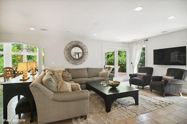 tiled living room featuring recessed lighting and french doors