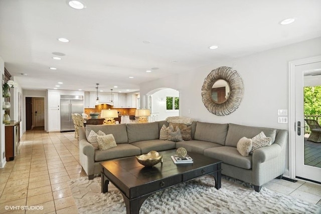 living area featuring recessed lighting and arched walkways