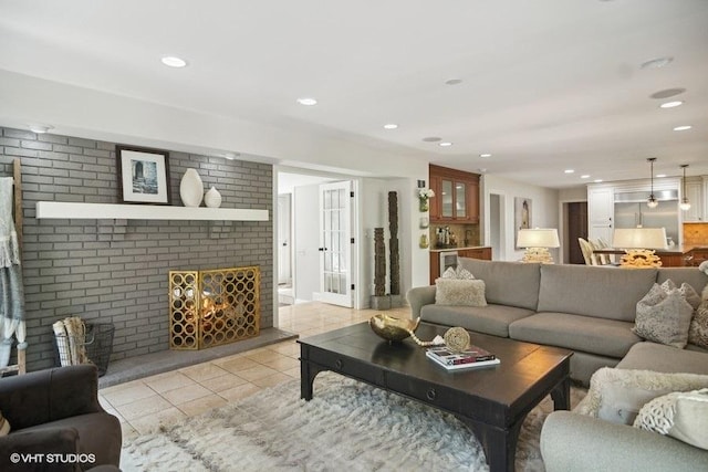 living room featuring recessed lighting, wine cooler, brick wall, light tile patterned floors, and a brick fireplace