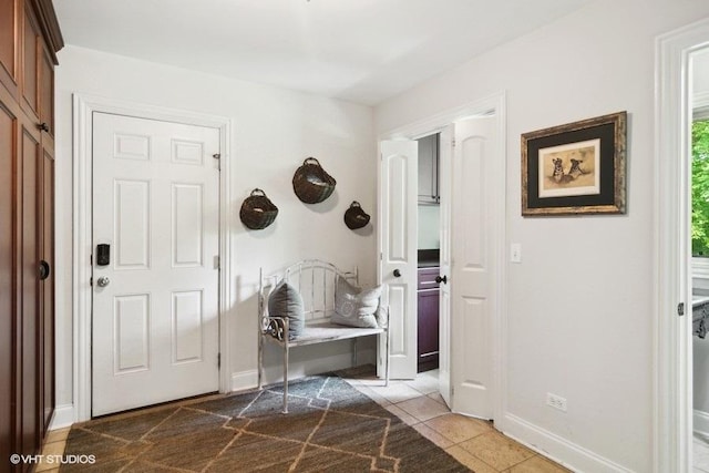 mudroom with tile patterned flooring and baseboards