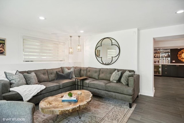 living room with recessed lighting, wine cooler, dark wood-type flooring, and a dry bar