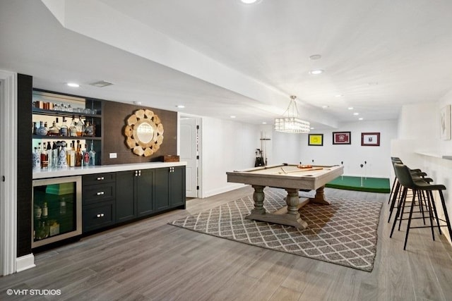 recreation room with wood finished floors, beverage cooler, recessed lighting, pool table, and a dry bar