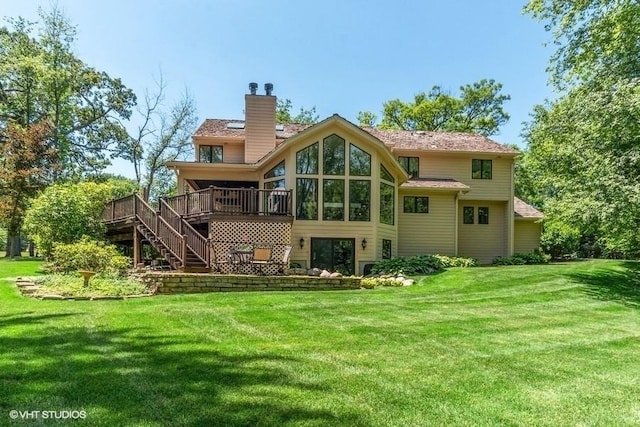 back of house featuring stairs, a wooden deck, a yard, and a chimney