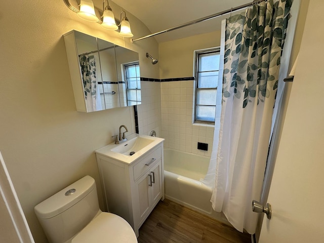 bathroom with wood finished floors, toilet, vanity, and shower / bathtub combination with curtain