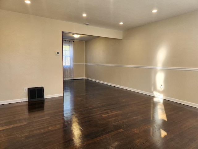 spare room with recessed lighting, wood finished floors, and baseboards