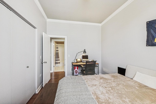 bedroom featuring a closet, ornamental molding, and wood finished floors