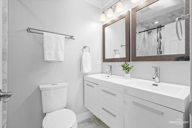 bathroom with double vanity, toilet, marble finish floor, and a sink