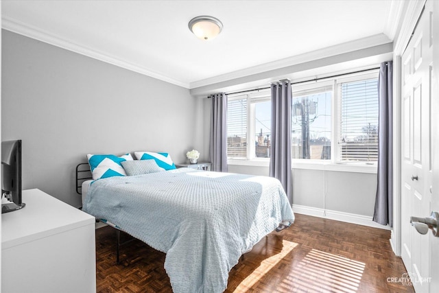 bedroom with baseboards, a closet, and ornamental molding