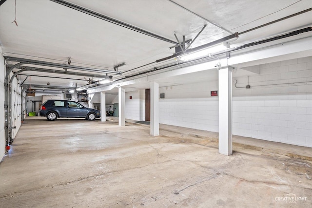 parking garage featuring concrete block wall