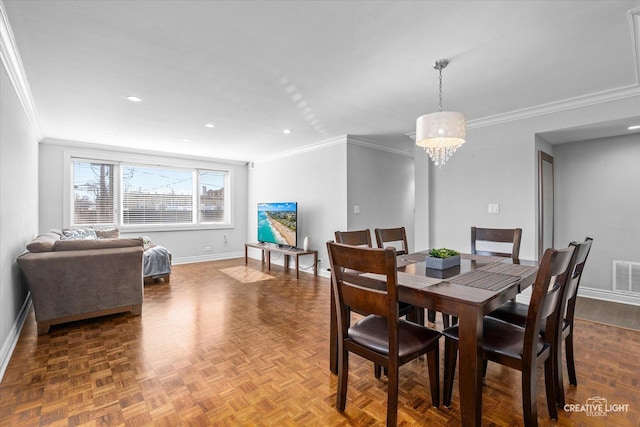 dining area with baseboards, an inviting chandelier, and crown molding