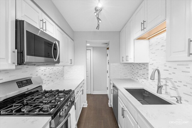 kitchen featuring a sink, stainless steel appliances, and white cabinets