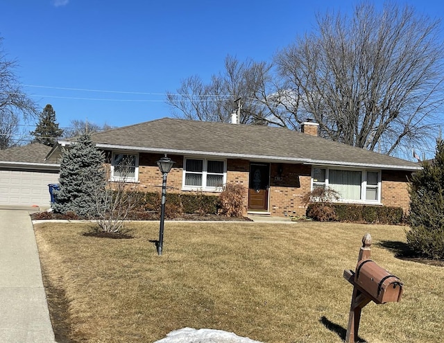 ranch-style house with roof with shingles, a chimney, a front lawn, a garage, and brick siding