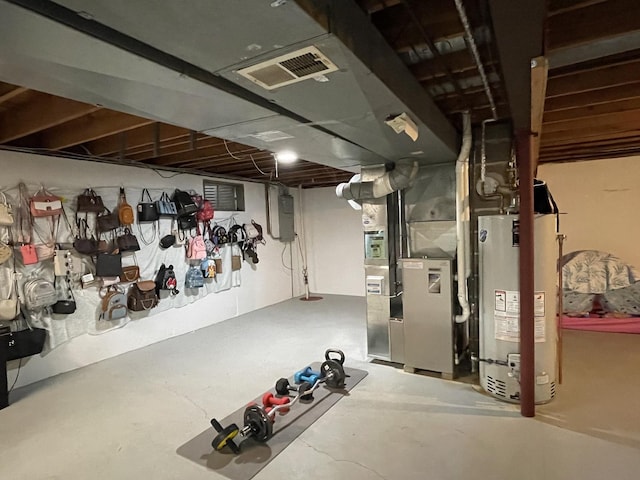 unfinished basement with visible vents, heating unit, and water heater