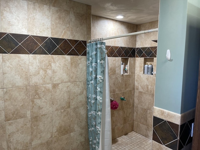 bathroom with a tile shower