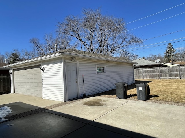 detached garage featuring fence