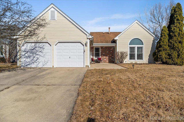 single story home featuring a front yard, brick siding, concrete driveway, and an attached garage