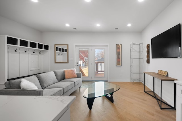 living area featuring recessed lighting, light wood-style floors, and baseboards