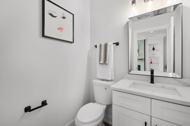 bathroom featuring toilet and vanity