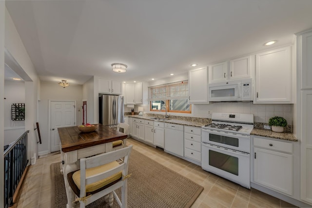421 Dodson St, Geneva, IL 60134 - kitchen featuring white appliances, a sink, white cabinets, light stone counters, and backsplash