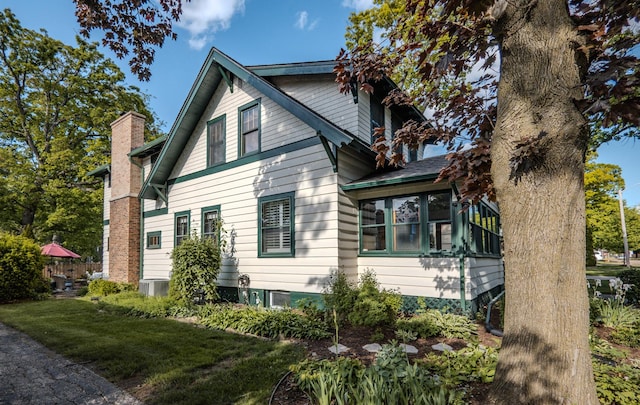421 Dodson St, Geneva, IL 60134 - view of side of property with a chimney, a sunroom, and central air condition unit