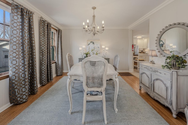 421 Dodson St, Geneva, IL 60134 - dining area featuring a chandelier, light wood-style floors, ornamental molding, and baseboards