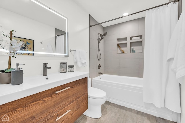 full bathroom with vanity, shower / bath combination with curtain, and toilet