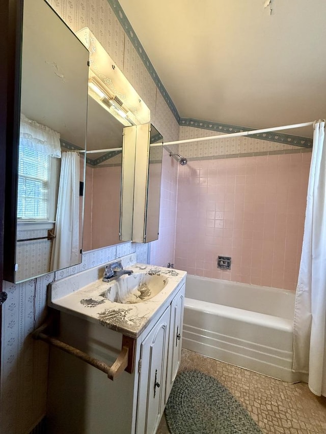 full bathroom with wallpapered walls, vanity, and shower / tub combo with curtain